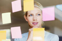 woman looking at post-it notes